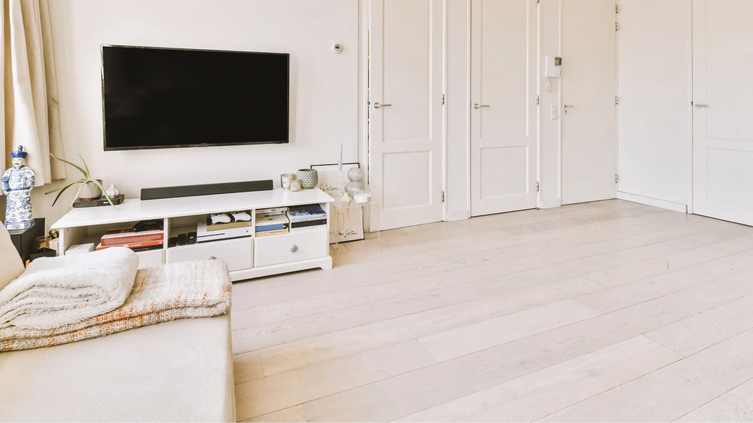 A spacious modern room with lounge and dining areas.